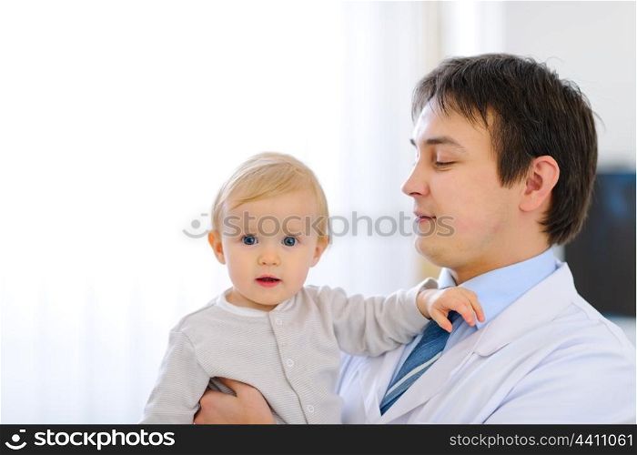 Portrait of adorable baby on hands of pediatrician&#xA;