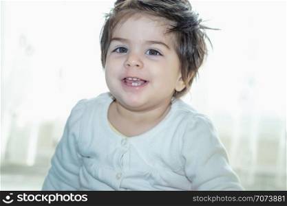 Portrait of adorable cute little baby girl toddler looking at camera . Portrait of adorable cute little baby girl