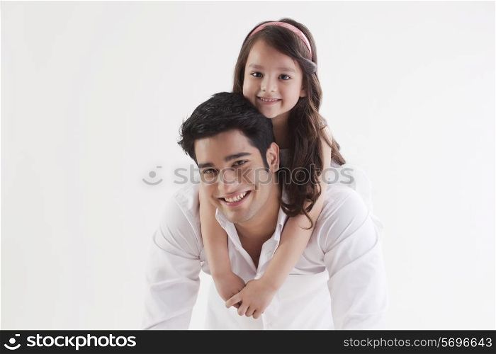Portrait of adorable girl sitting on her father&rsquo;s back