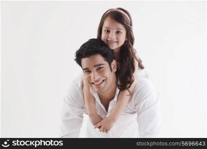 Portrait of adorable girl sitting on her father&rsquo;s back