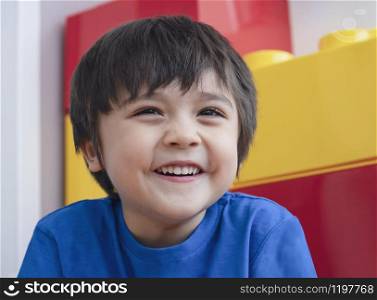 Portrait of adorable kid looking out with smiling face, Head shot mixed race child, Photo of cute young happy boy, Positive kid concept