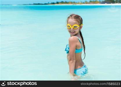 Portrait of adorable little girl on the beach during summer vacation. Cute little girl at beach during summer vacation