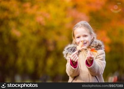 Portrait of adorable little girl outdoors at beautiful autumn day outdoors. Adorable little girl at beautiful autumn day outdoors