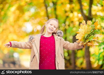 Portrait of adorable little girl with yellow leaves bouquet in fall at autumn park outdoors. Portrait of adorable little girl with yellow leaves bouquet in fall