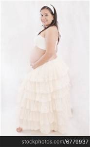 Portrait of adorable pregnant woman in antique dress