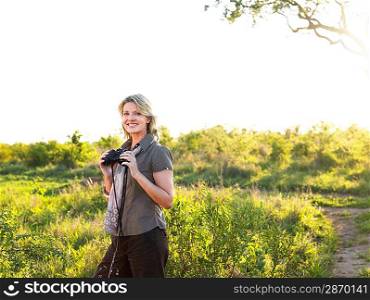 Portrait of adult woman holding binoculars