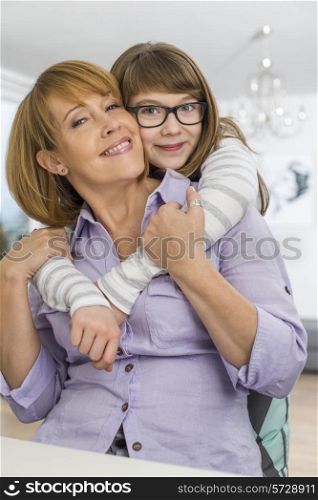 Portrait of affectionate daughter embracing mother at home