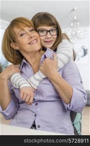 Portrait of affectionate daughter embracing mother at home