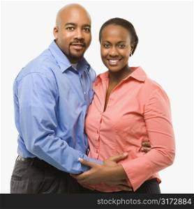 Portrait of African American couple with arms around eachother against white background.