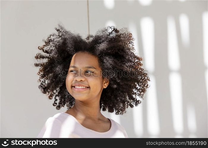 portrait of African American curly hair girl smiling with happiness and looking at camera.