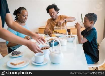 Portrait of African american family having breakfast together at home. Family and lifestyle concept.