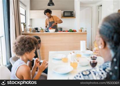 Portrait of African american family having lunch together at home, father cooked lunch for family. Family and lifestyle concept.