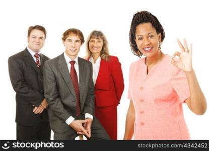 Portrait of african-american female business woman with her team, giving the Okay sign. Isolated on white.