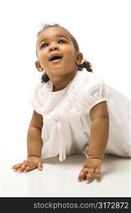 Portrait of African American infant girl against white background.