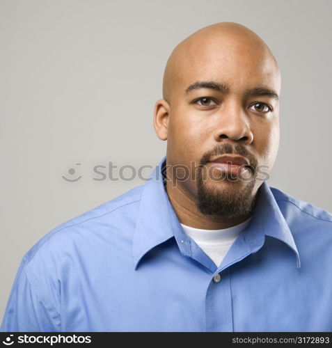 Portrait of African American man against gray background.