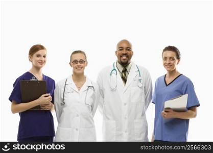 Portrait of African-American man and Caucasian women medical healthcare workers smiling in uniforms standing against white background.