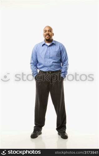 Portrait of African American man standing against white background.