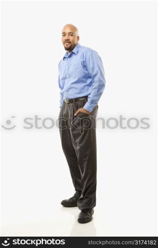 Portrait of African American man standing against white background.