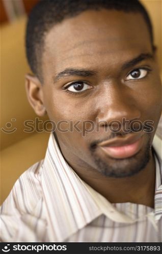 Portrait of African American mid adult man looking at viewer.