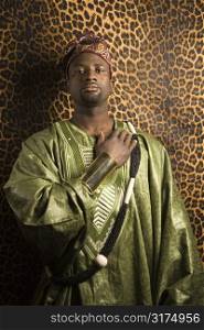 Portrait of African- American mid-adult man wearing traditional African clothing.