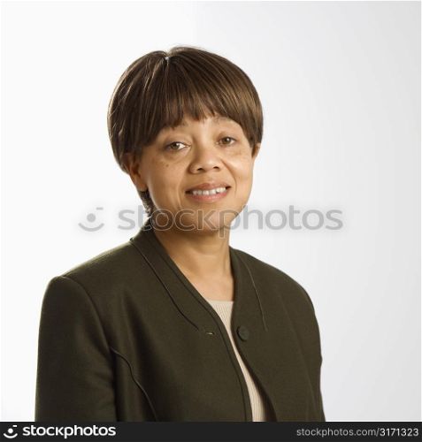 Portrait of African American middle-aged woman smiling and looking at viewer.
