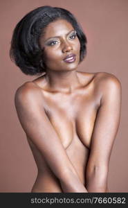 Portrait of african american woman posing naked in studio