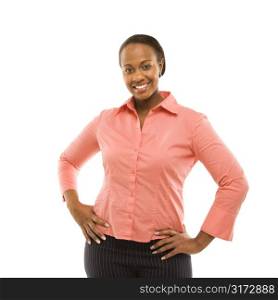 Portrait of African American woman standing smiling against white background.