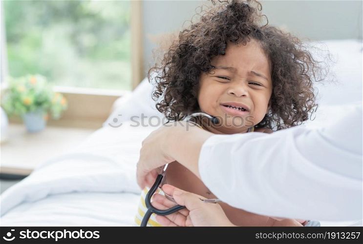 Portrait of African black little girl making funny face, wearing stethoscope and pretending to be a doctor and wearing stethoscope. Education Concept.
