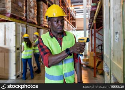 Portrait of african black warehouse worker hold hand scanner to do inventory work stock in distribution warehouse. Traceability FIFO LIFO inventory just in time and warehouse concept photo.