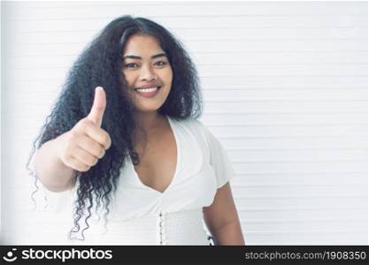 Portrait of african black woman making thumb up and standing with confidence with white background and copy space