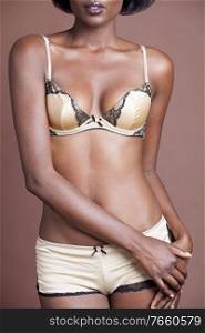 Portrait of african woman wearing sexy lingerie in studio