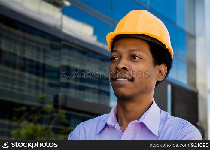 Portrait of Afro american engineer developer in hard hat outdoors.