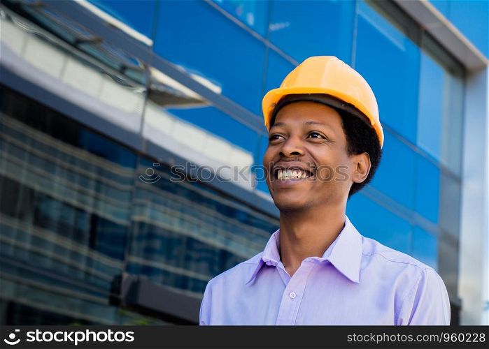 Portrait of Afro american engineer developer in hard hat outdoors.