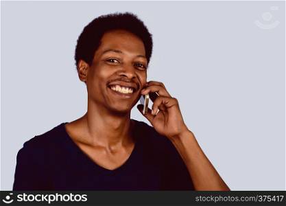 Portrait of Afro American man talking on his phone. Communication concept.