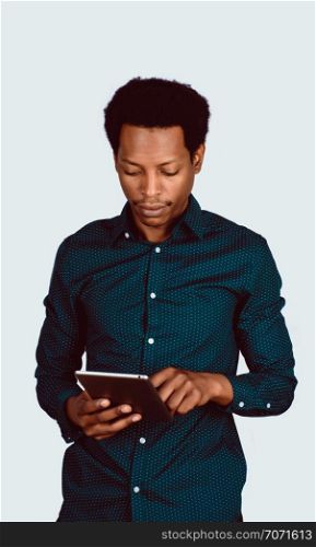 Portrait of Afro American man using digital tablet on studio.