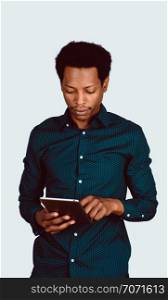 Portrait of Afro American man using digital tablet on studio.