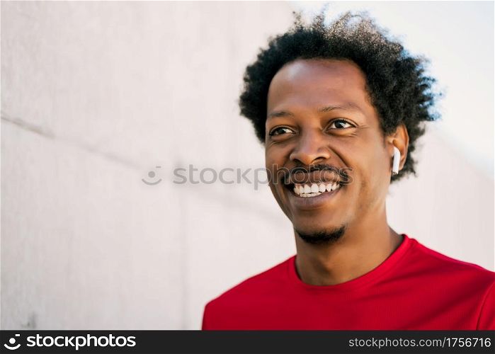 Portrait of afro athlete man standing outdoors on the street. Sport and healthy lifestyle.
