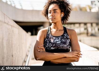 Portrait of afro athlete woman standing outdoors on the street. Sport and healthy lifestyle.