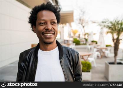 Portrait of afro tourist man standing outdoors on the street. Urban and lifestyle concept.