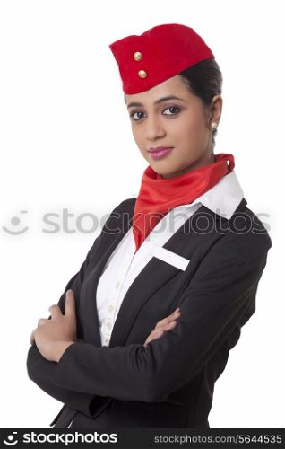Portrait of air hostess with arms crossed standing against white background