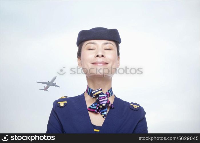 Portrait of air stewardess, eyes closed