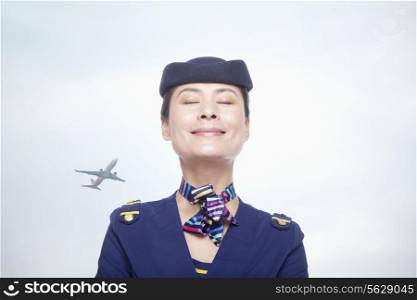 Portrait of air stewardess, eyes closed