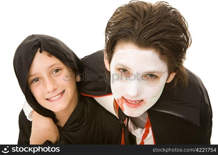 Portrait of an adolescent boy and his little brother, both dressed for Halloween. Isolated on white.