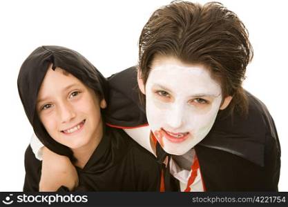 Portrait of an adolescent boy and his little brother, both dressed for Halloween. Isolated on white.