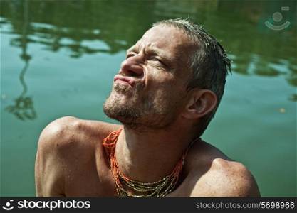 Portrait of an adult man bathing in a lake