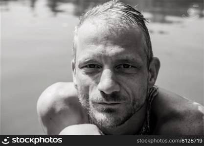 Portrait of an adult man bathing in a lake