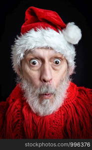 Portrait of an adult man with white beard disguised in Santa Claus for the Christmas Holiday