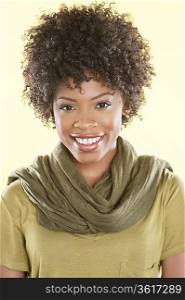 Portrait of an African American woman smiling with a stole round her neck over colored background