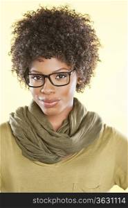 Portrait of an African American woman wearing glasses over colored background