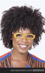Portrait of an African American woman wearing glasses over gray background